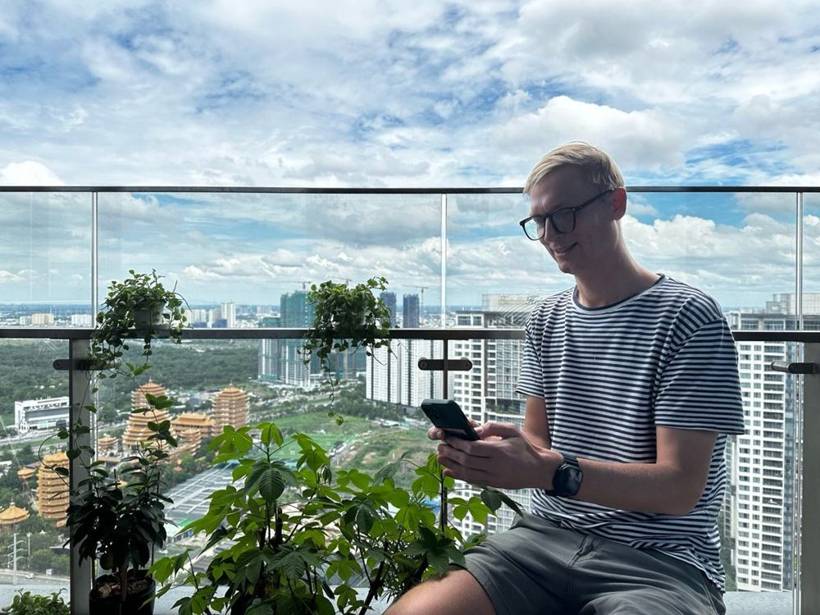 Daan building on Replit from his phone on a balcony in Ho Chi Minh City