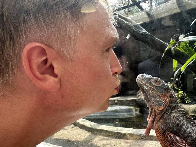 Daan up close with an iguana while his Replit bot trades automatically